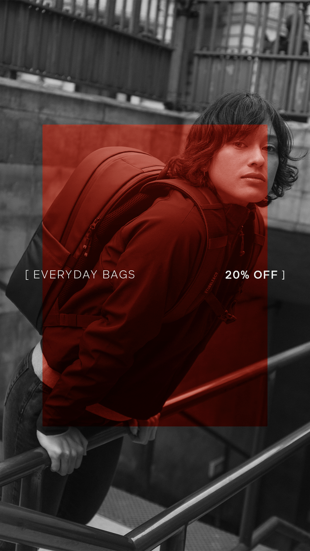 A woman leaning over a bannister on stairs with an everyday backpack 20l on her back with the Members Week creative overlayed 