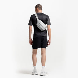 A man wearing an Ash Motion Sling 4L across his back