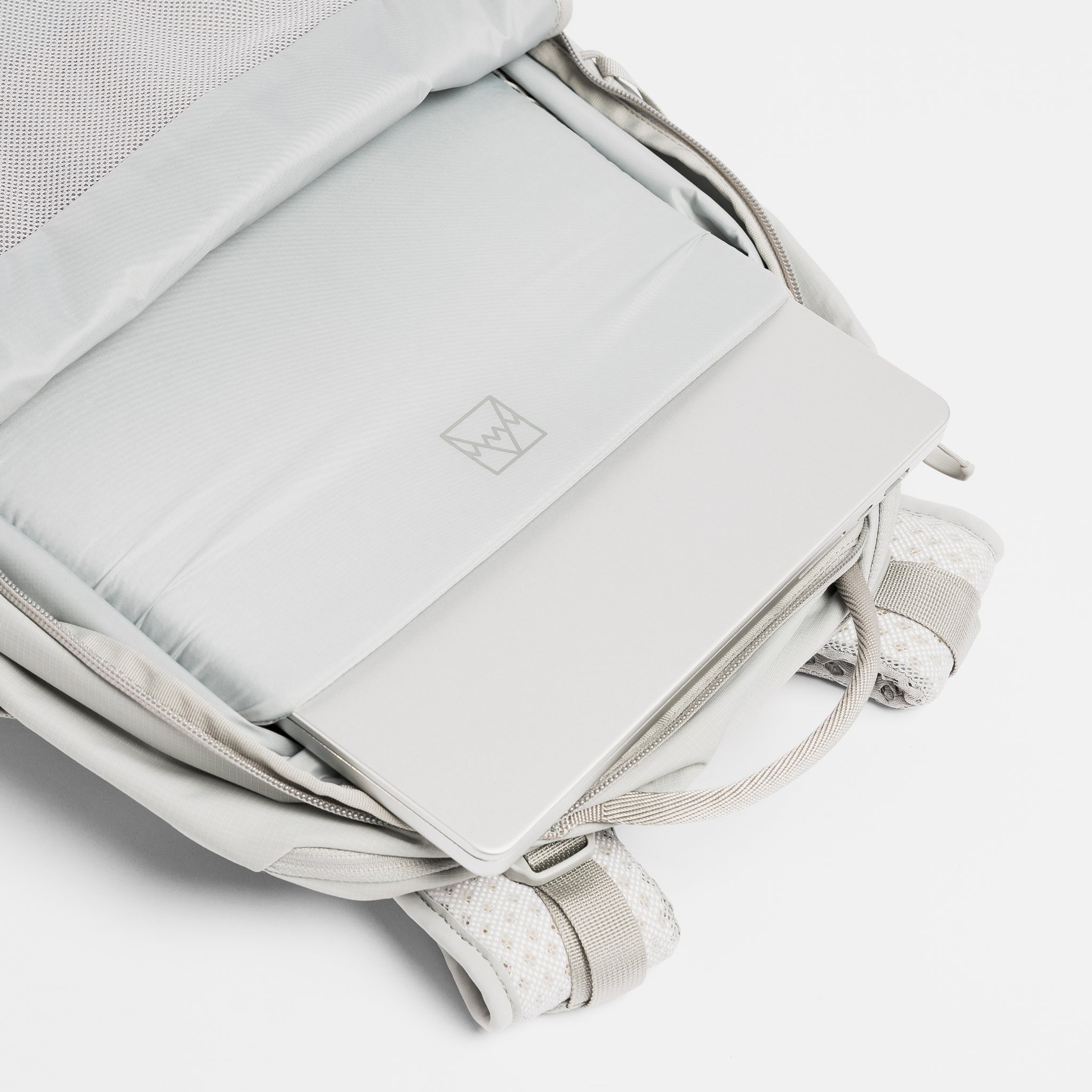 A studio shot of the laptop compartment inside the Motion Adventure Pack 38L in Ash