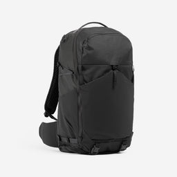 Motion Adventure Pack 38L in Charcoal, front angle with straps tucked away.