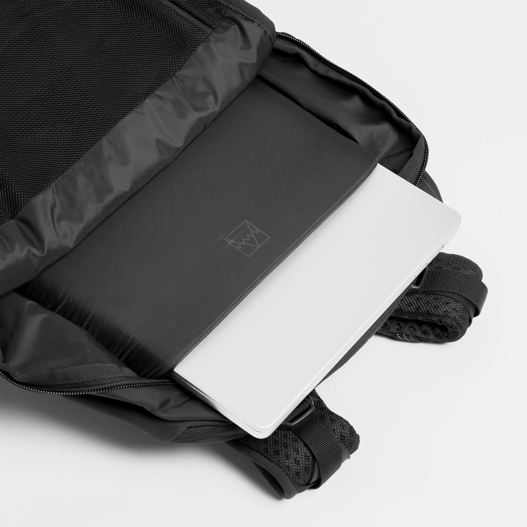 A studio shot of the laptop compartment within the Motion Adventure Pack 38L in Charcoal 