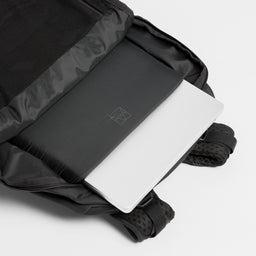 A studio shot of the laptop compartment within the Motion Adventure Pack 38L in Charcoal 