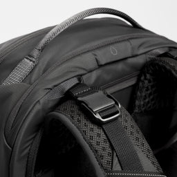 A close up shot of the load lifters and hydration hose pass through on the Motion Adventure Pack 38L in Ash and Charcoal