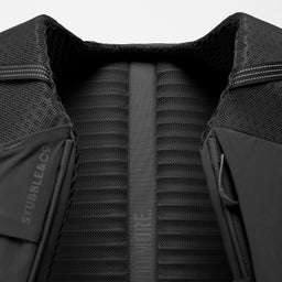 A studio shot of the breathable back panel on the Charcoal Motion Backpack 20L as well as Magma and Ash Backpack 20Ls