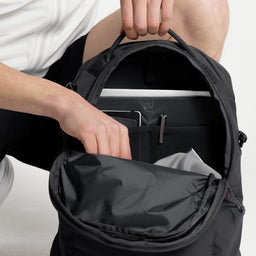 A studio shot of the interior organisation of the Charcoal Motion Backpack 20L  as well as Magma and Ash Backpack 20Ls