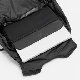 A studio shot of the interior laptop compartment in the Charcoal Motion Backpack 20L