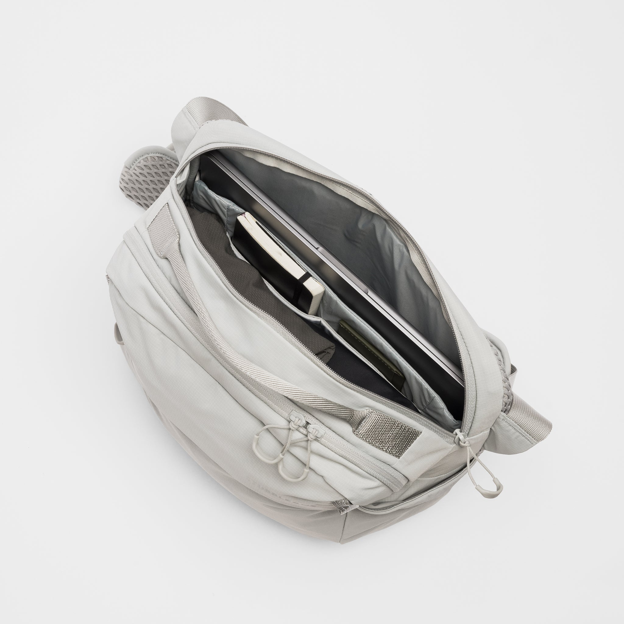 A studio shot of the interior compartments of the Ash Motion Sling 15L