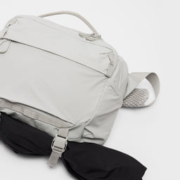 A studio shot of the extra gear strap and quick release clips on the Ash Motion Sling 15L