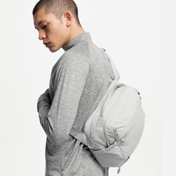 A studio shot of a model wearing an Ash Motion Sling 15L on his back