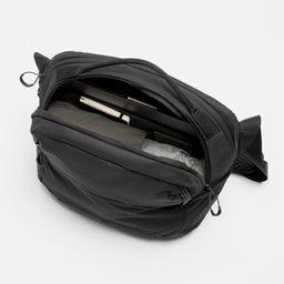 A studio shot of the interior pockets on the Charcoal Motion Sling 15L