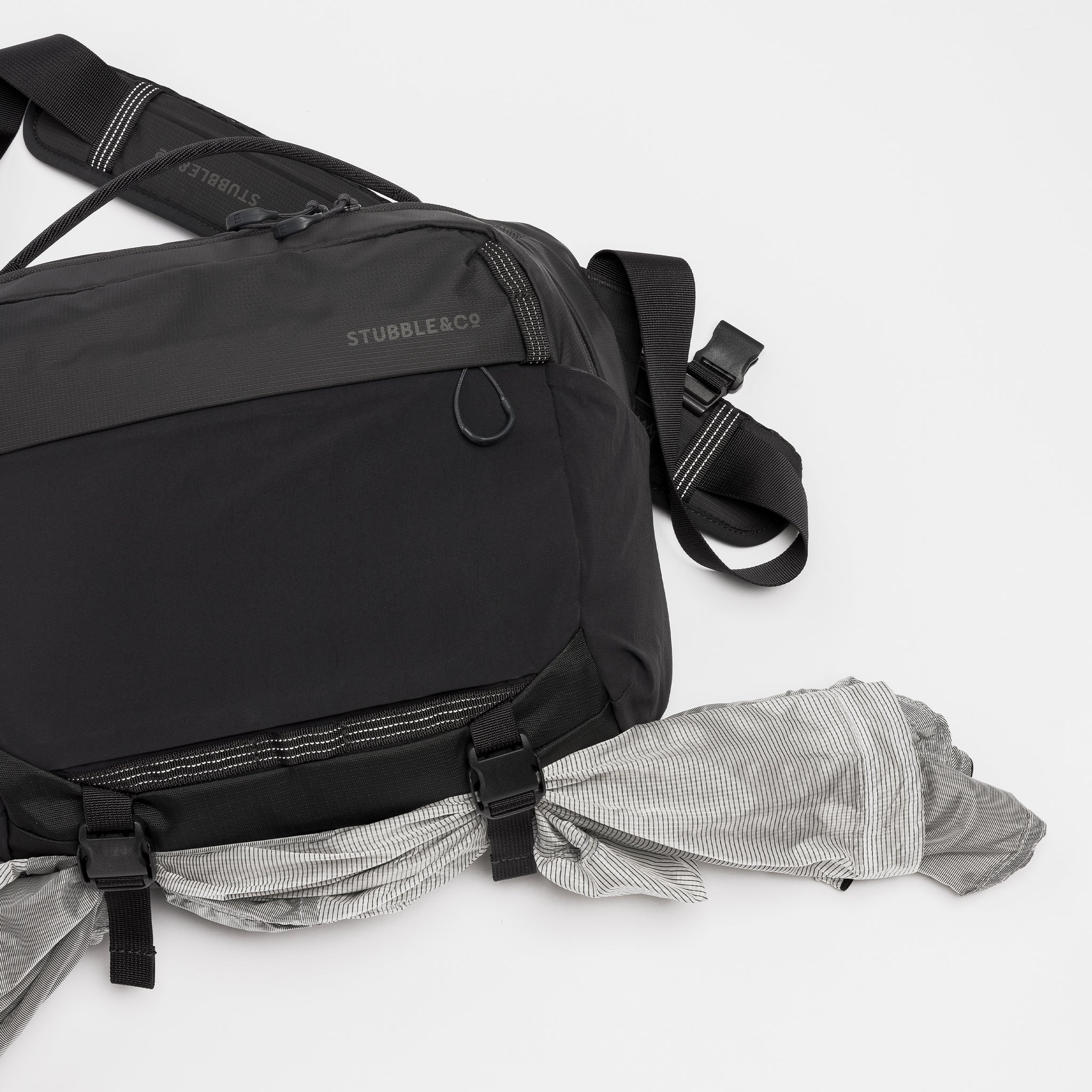 A studio shot of the external gear straps and quick release clips on the Charcoal Motion Sling 15L