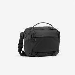 A studio shot of the front and side of the Charcoal Motion Sling 15L