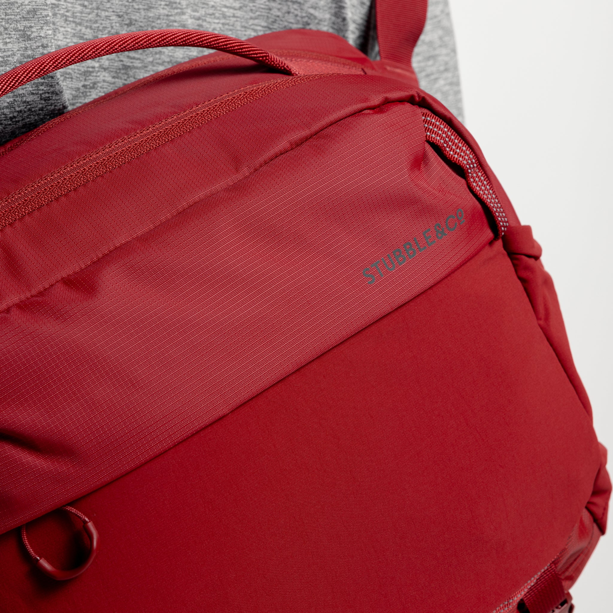 A studio shot of the close up of the front material and reflective logo on the Magma Motion Sling 15L
