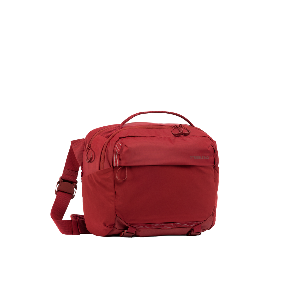 A studio shot of the front and side of an motion sling 15l as cut out transparent PNG- magma