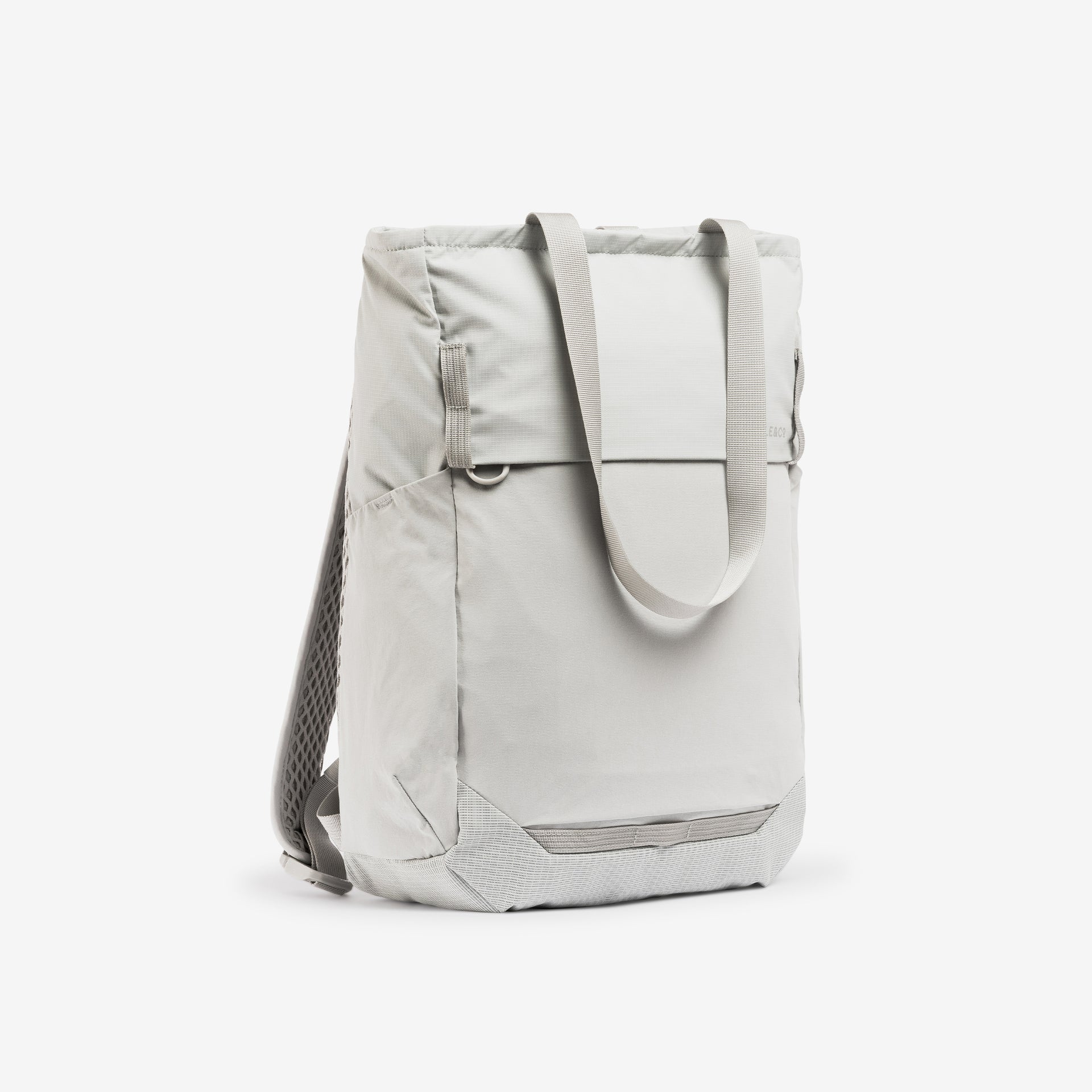 A studio shot of the front and side of the Ash Motion Tote Pack 18L