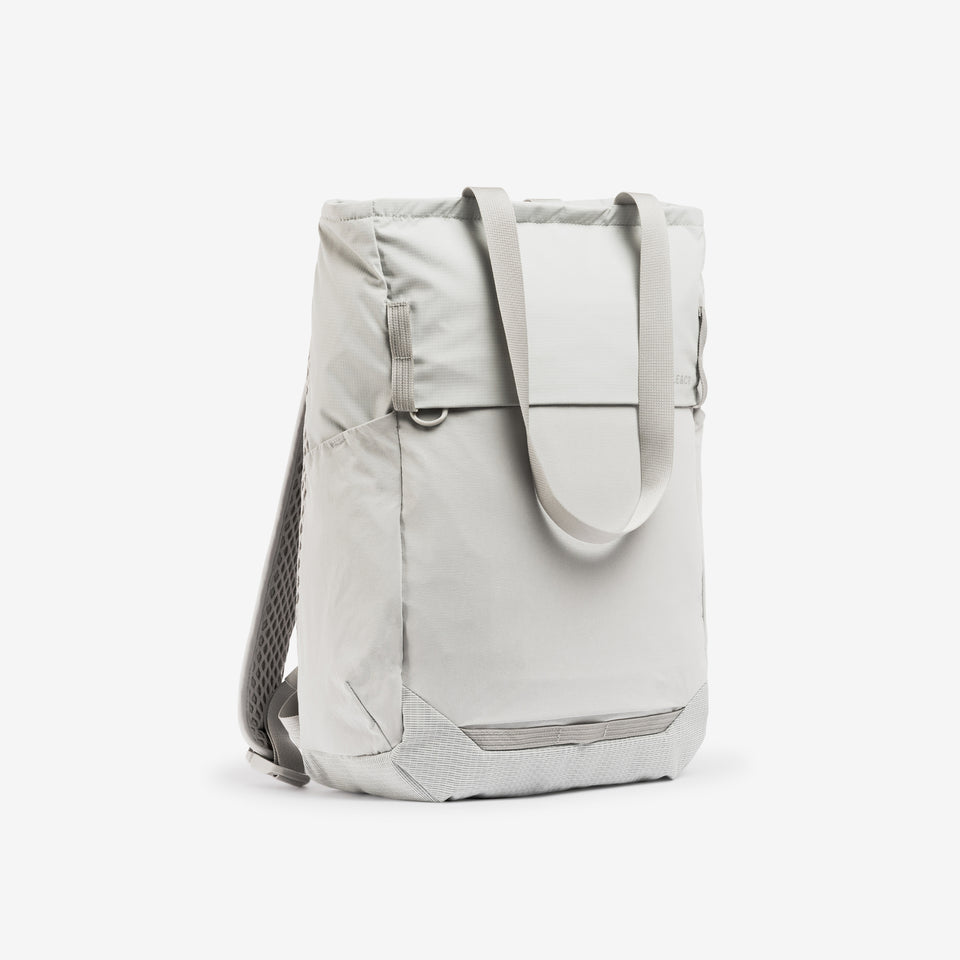 A studio shot of the front and side of the Ash Motion Tote Pack 18L