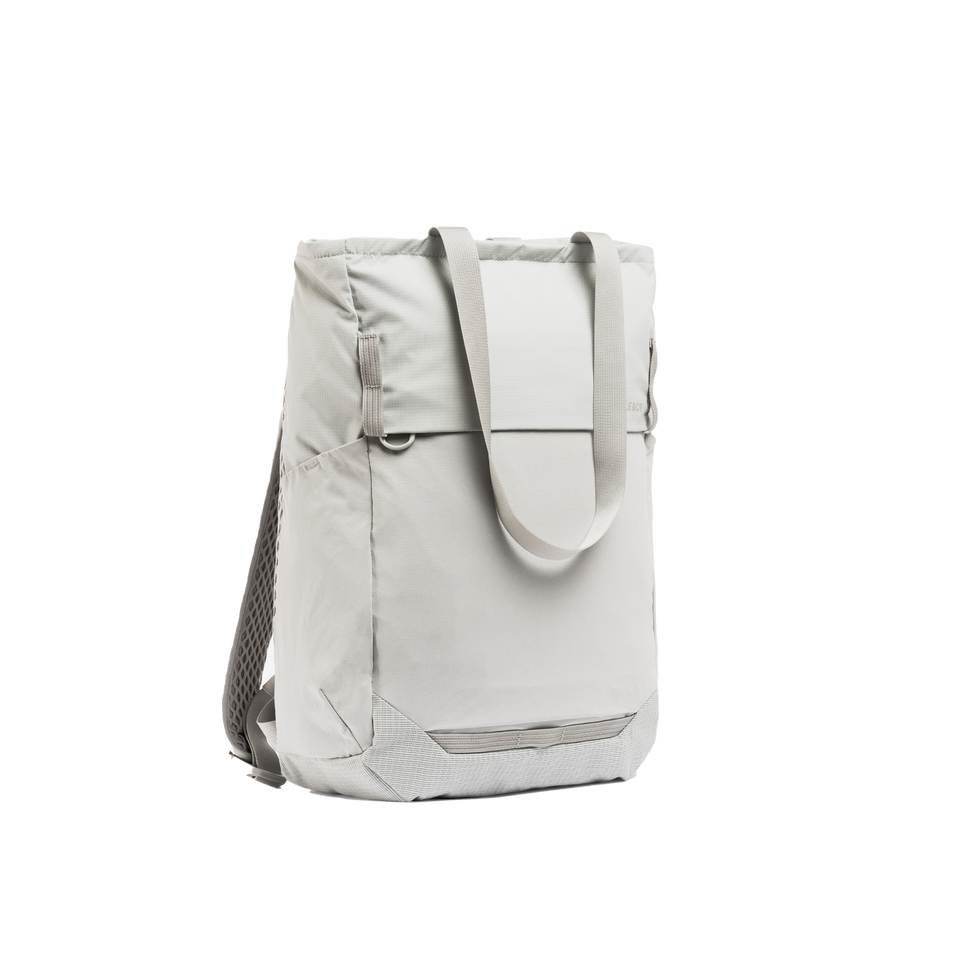 A studio shot of the front and side of an motion tote pack 18l as cut out transparent PNG- ash