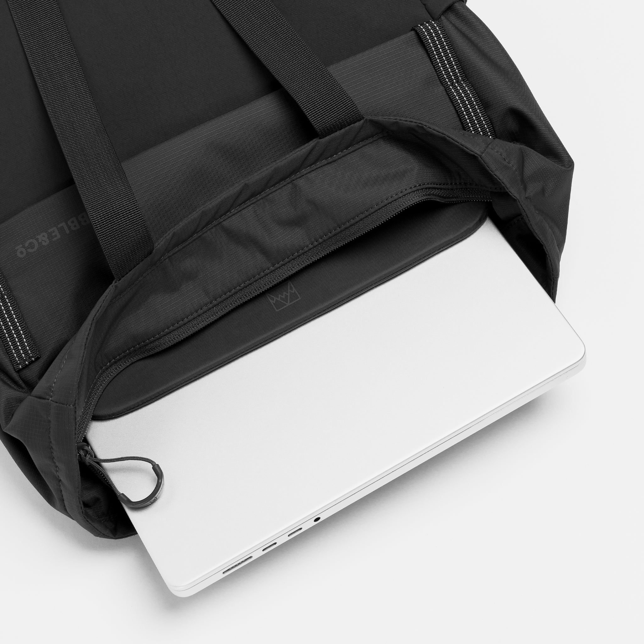 A studio shot of the internal laptop compartment within the Charcoal Motion Tote Pack 18L