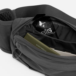 A studio shot of the interior compartments for the Charcoal Motion Waist Pack 2L