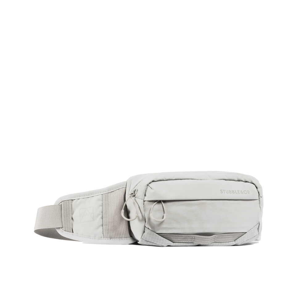 A studio shot of the front and side of a motion waist pack 2l as cut out transparent PNG- ash