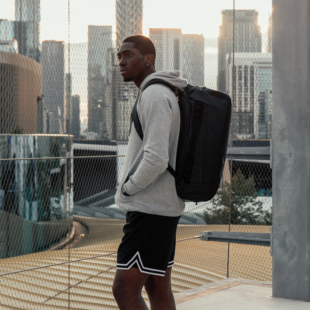 Man wearing The Kit Bag All Black Backpack