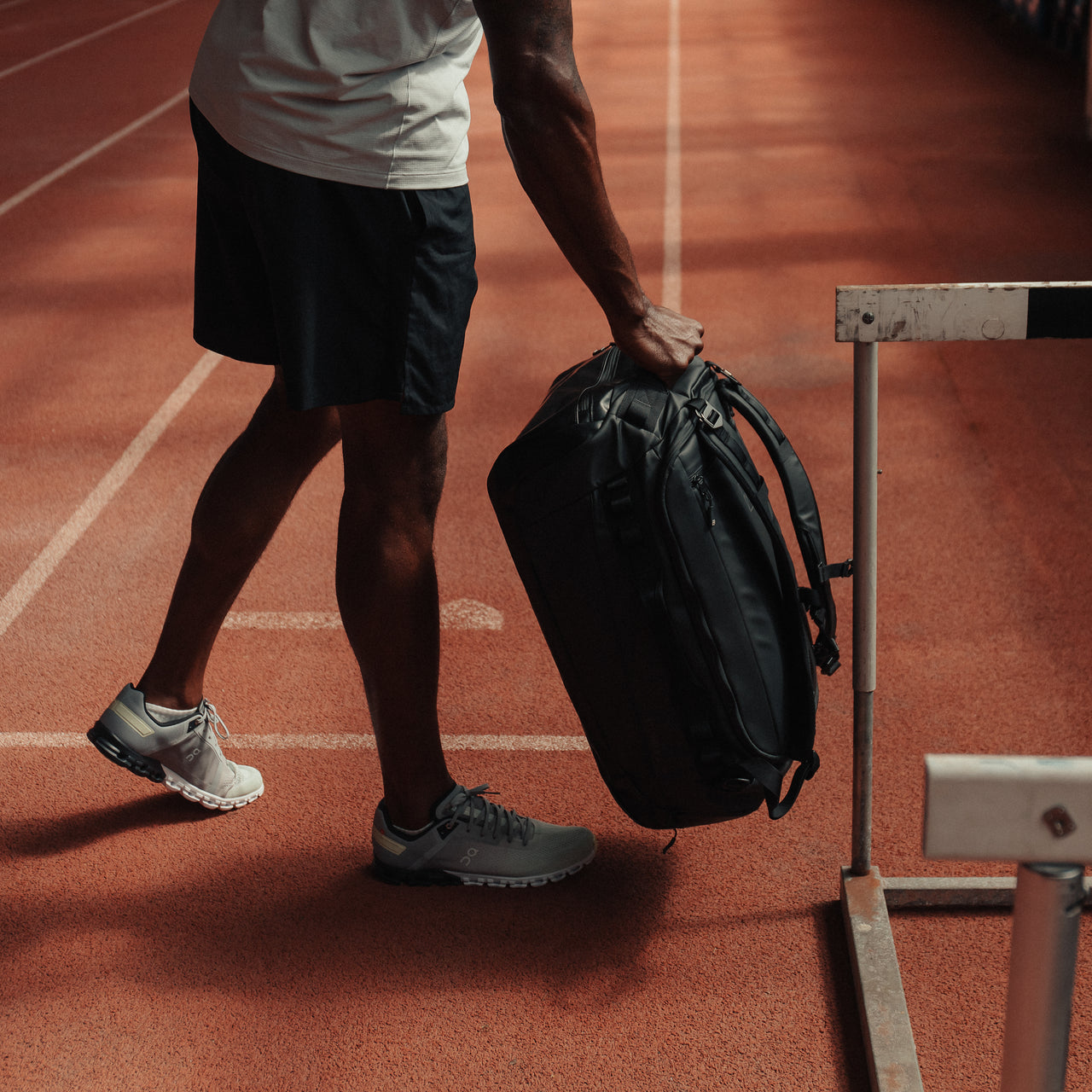 Man holding The Kit Bag All Black Backpack