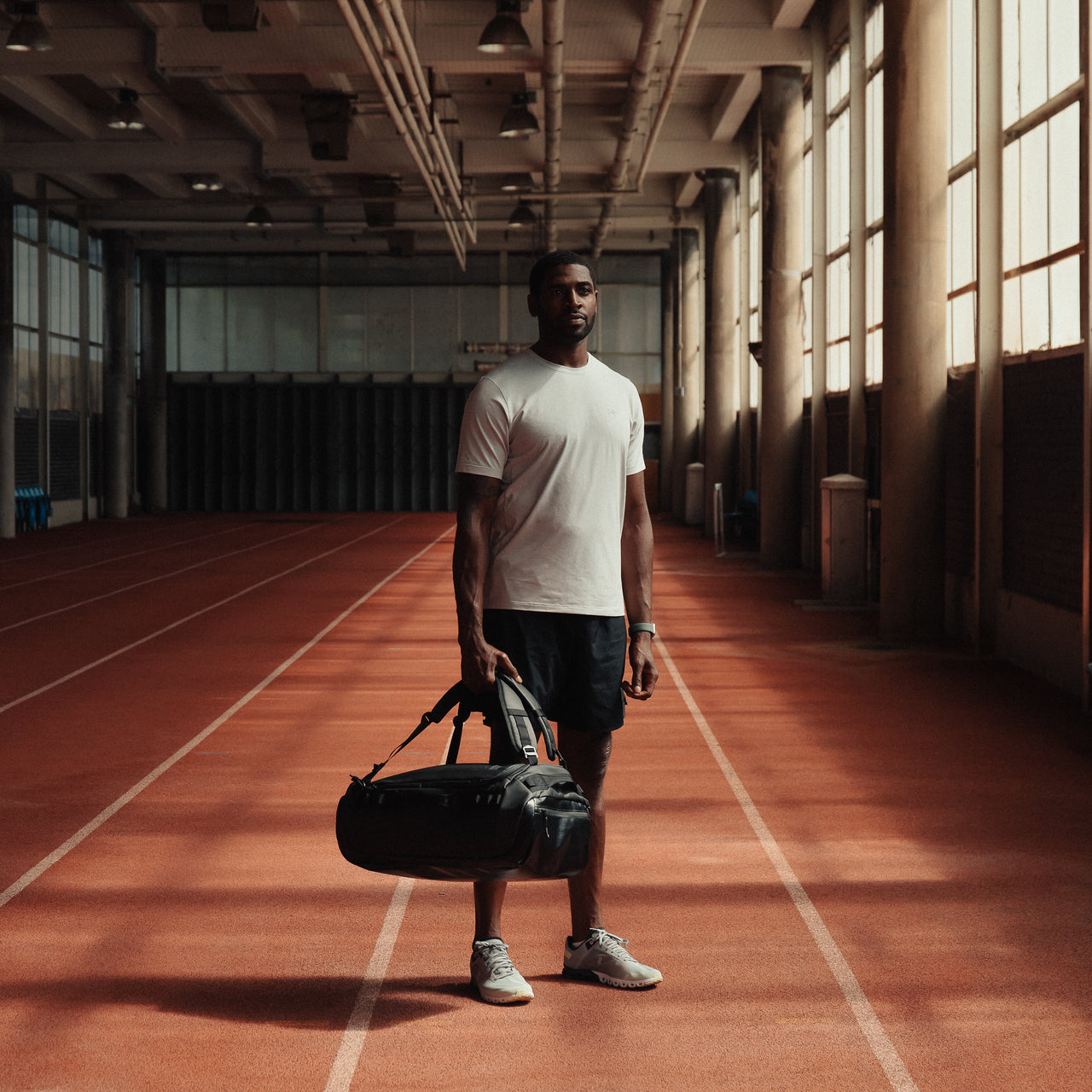 Man holding The Kit Bag All Black Backpack