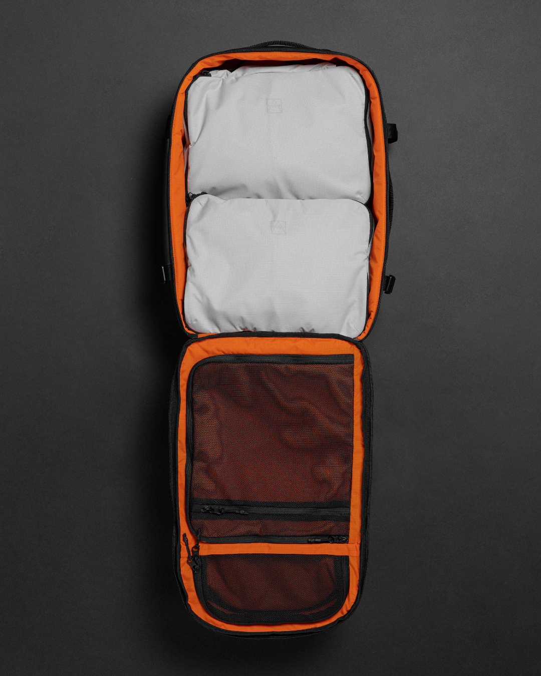 Kit Bag unzipped and laid open, filled with off-white packing cubes.