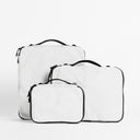 A studio shot of all the packing cube sizes in Off-White