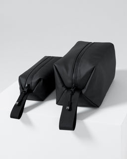 A studio shot of the Wash Bag and Wash Bag Mini side by side  Urban Green