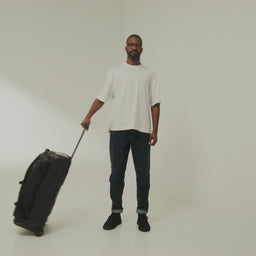 A studio video of the All Black Wheeled Duffel 80L in All Black showing all the features