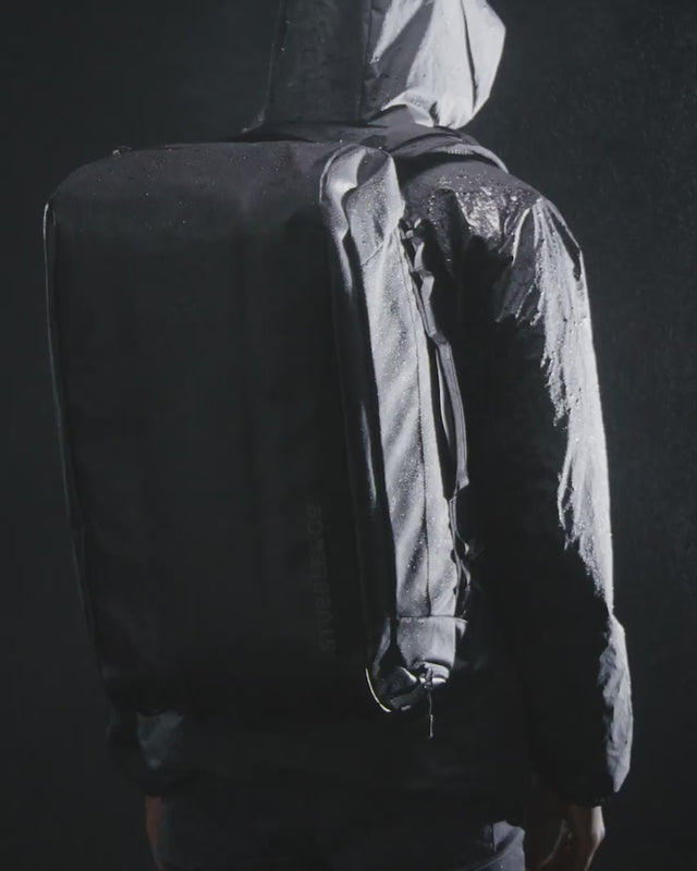 a video of water falling onto a Kit Bag 40L in a studio