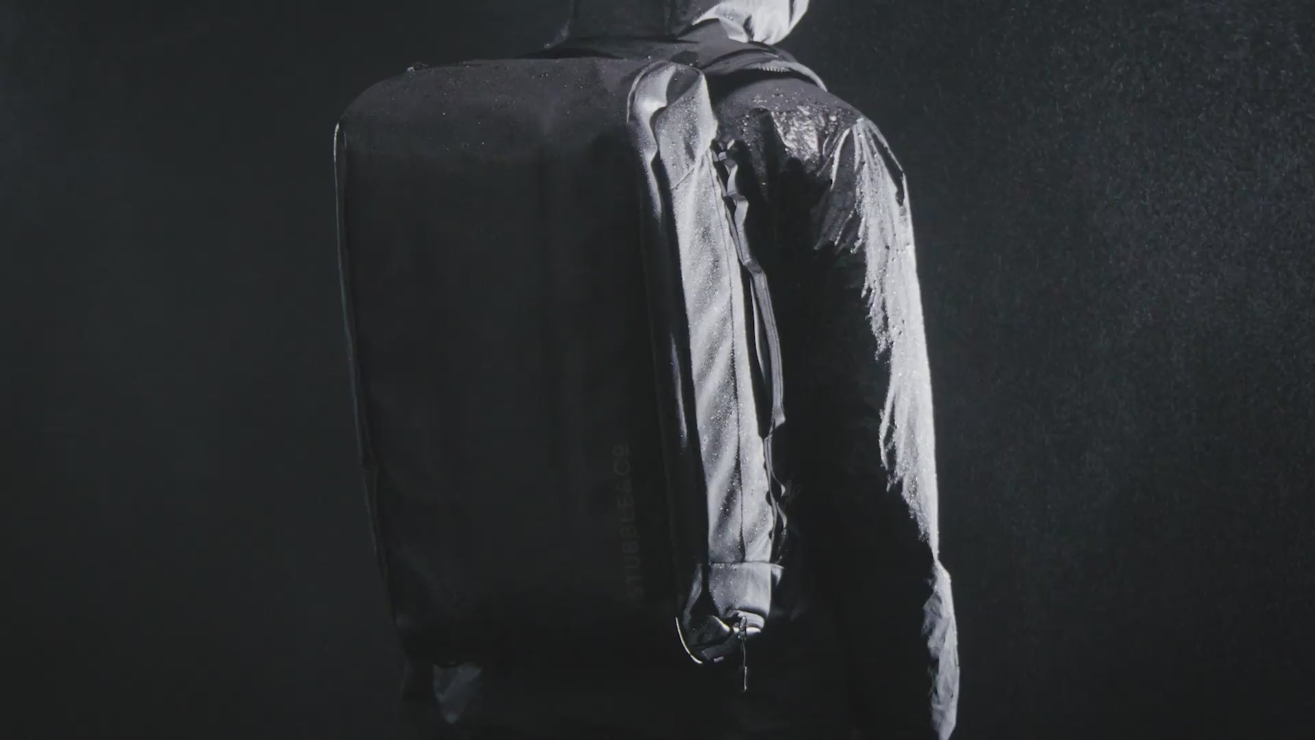 a video of water falling onto a Kit Bag 40L in a studio