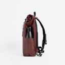 A studio shot of the side bottle pocket on the Roll Top 15L in Garnet Red