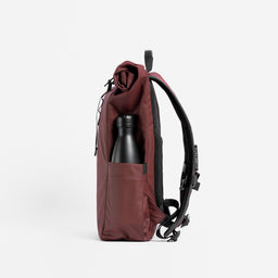 A studio shot of the side bottle pocket on the Roll Top 15L in Garnet Red