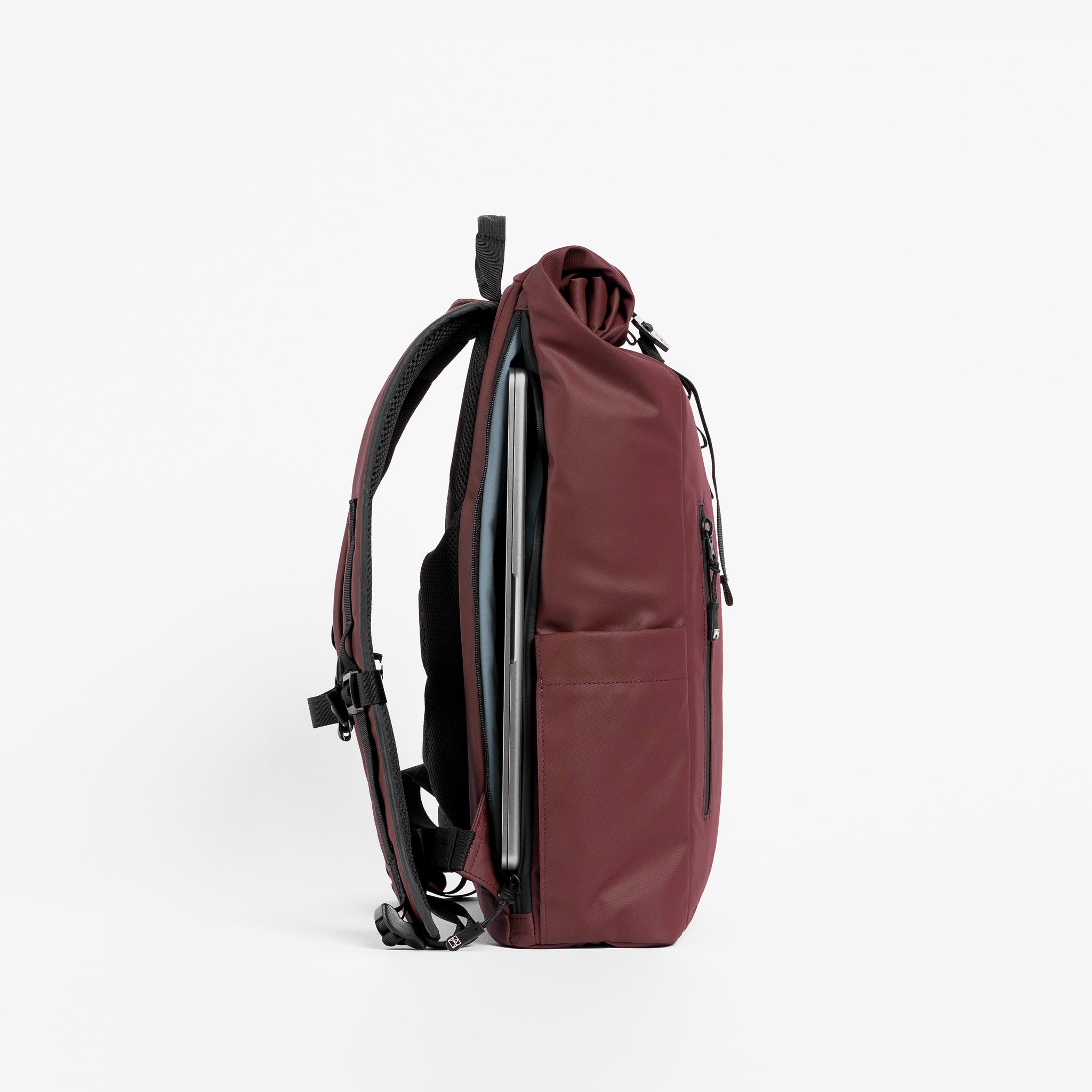 A studio shot of the side laptop compartment on the Roll Top 15L in Garnet Red