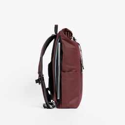 A studio shot of the side laptop compartment on the Roll Top 15L in Garnet Red