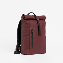 A studio shot of the front and side of the garnet red roll top 15l- shop all