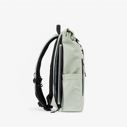 A studio shot of the laptop compartment on  the Roll Top 15L in Soft Mint