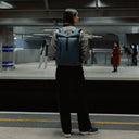 Women wearing the Roll Top 15L in Tasmin Blue at a train station