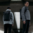 A man and woman wearing All Black Roll Top 20Ls on their backs