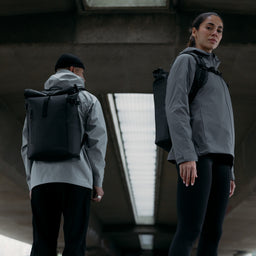 A man and woman wearing All Black Roll Top 20Ls on their backs
