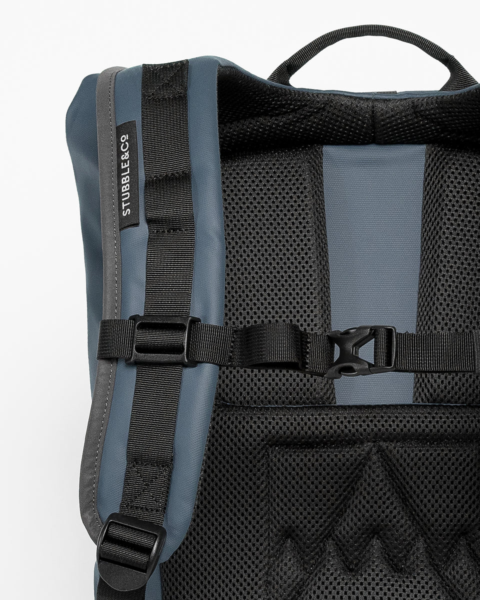 A studio shot of a blue roll top 15l showing the upgraded fully adjustable chest straps