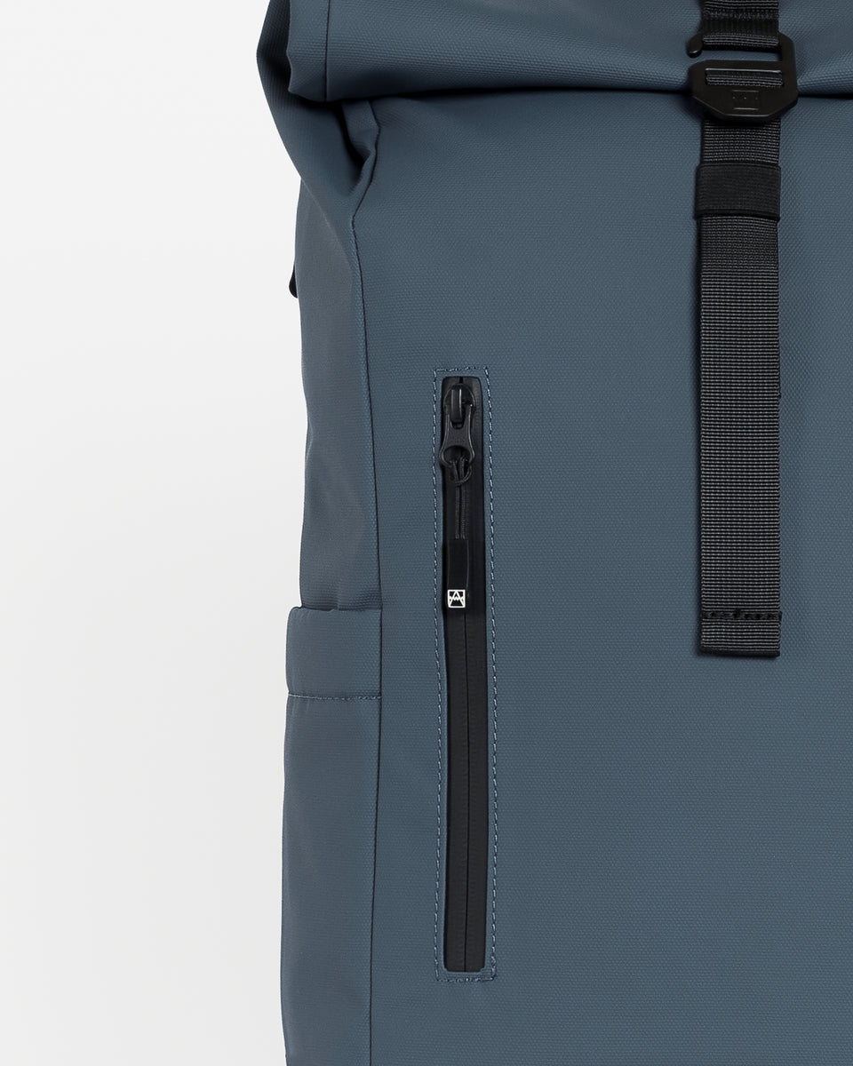 Close up of the zip on the front of the Roll Top backpack