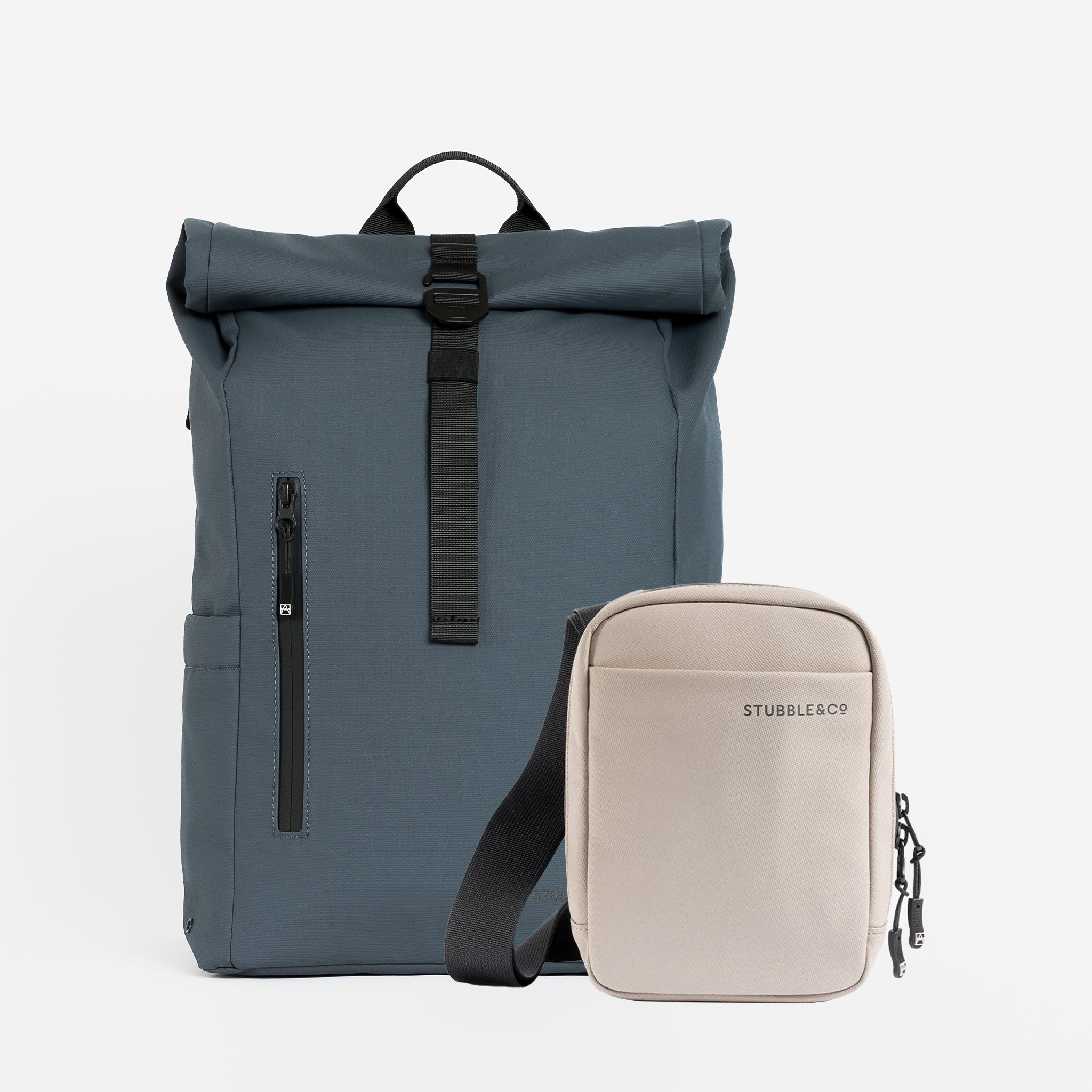 A studio shot of a Roll Top 20L and a Shoulder Bag in Tasmin Blue / Sand
