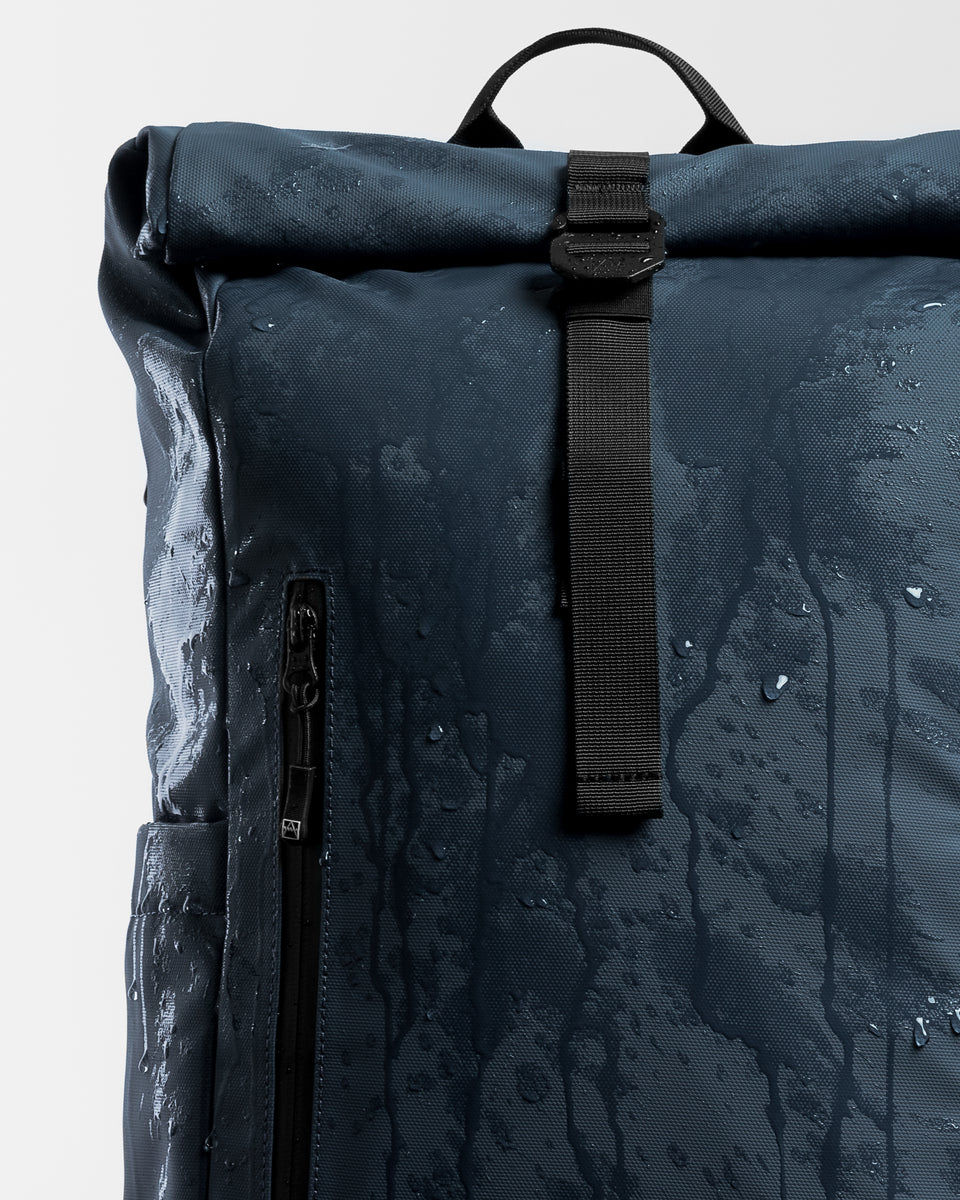 A studio shot of a blue roll top 15l showing its waterproof material