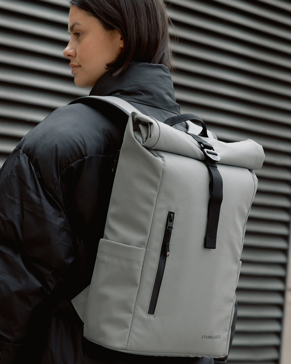 a close up of the back panel of a concrete roll top 15l on a woman's back