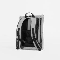 A studio shot of the back panel and adjustable chest straps on the Concrete Roll Top 15L