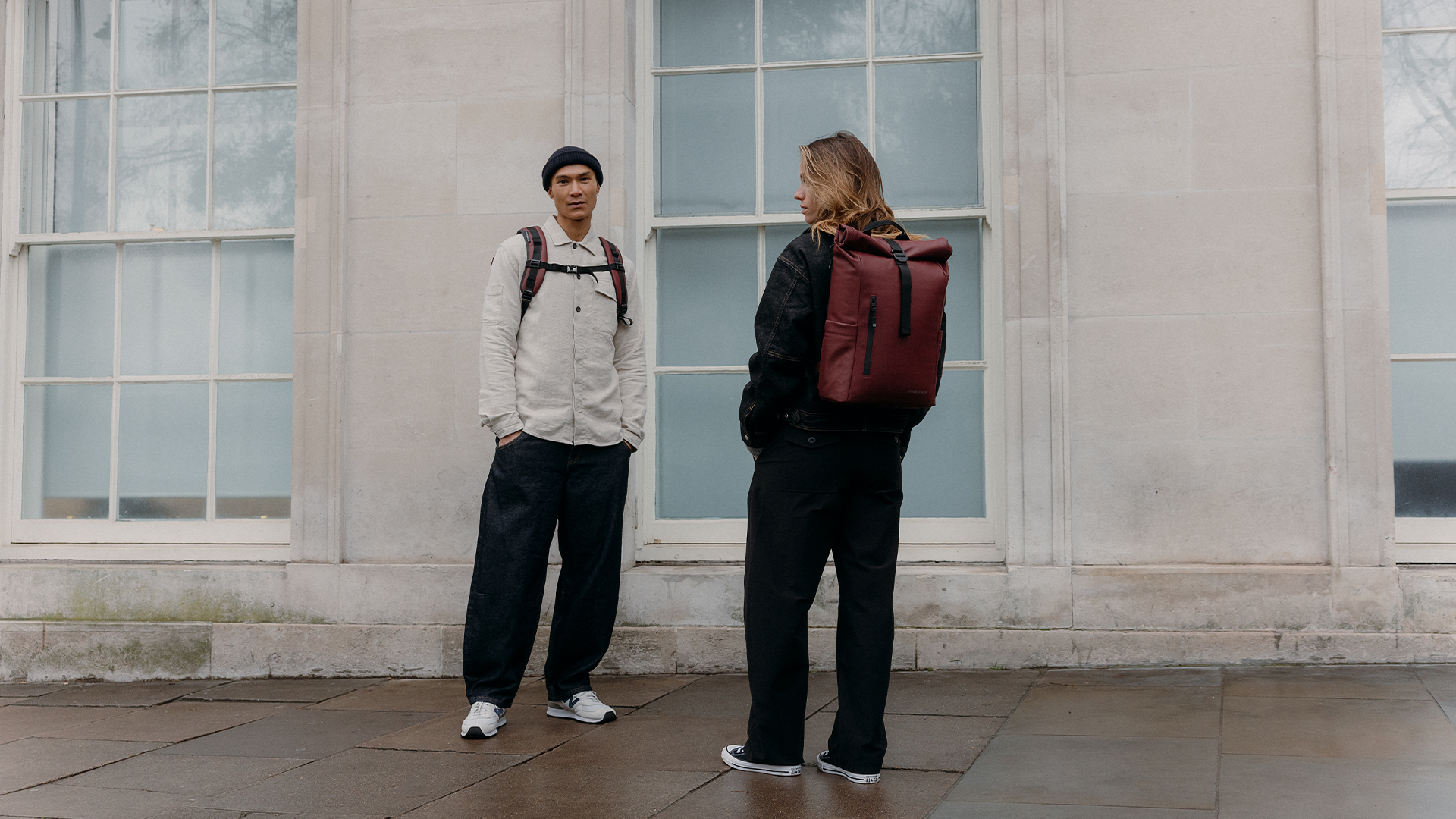 A man and woman wearing garnet red roll tops on their backs