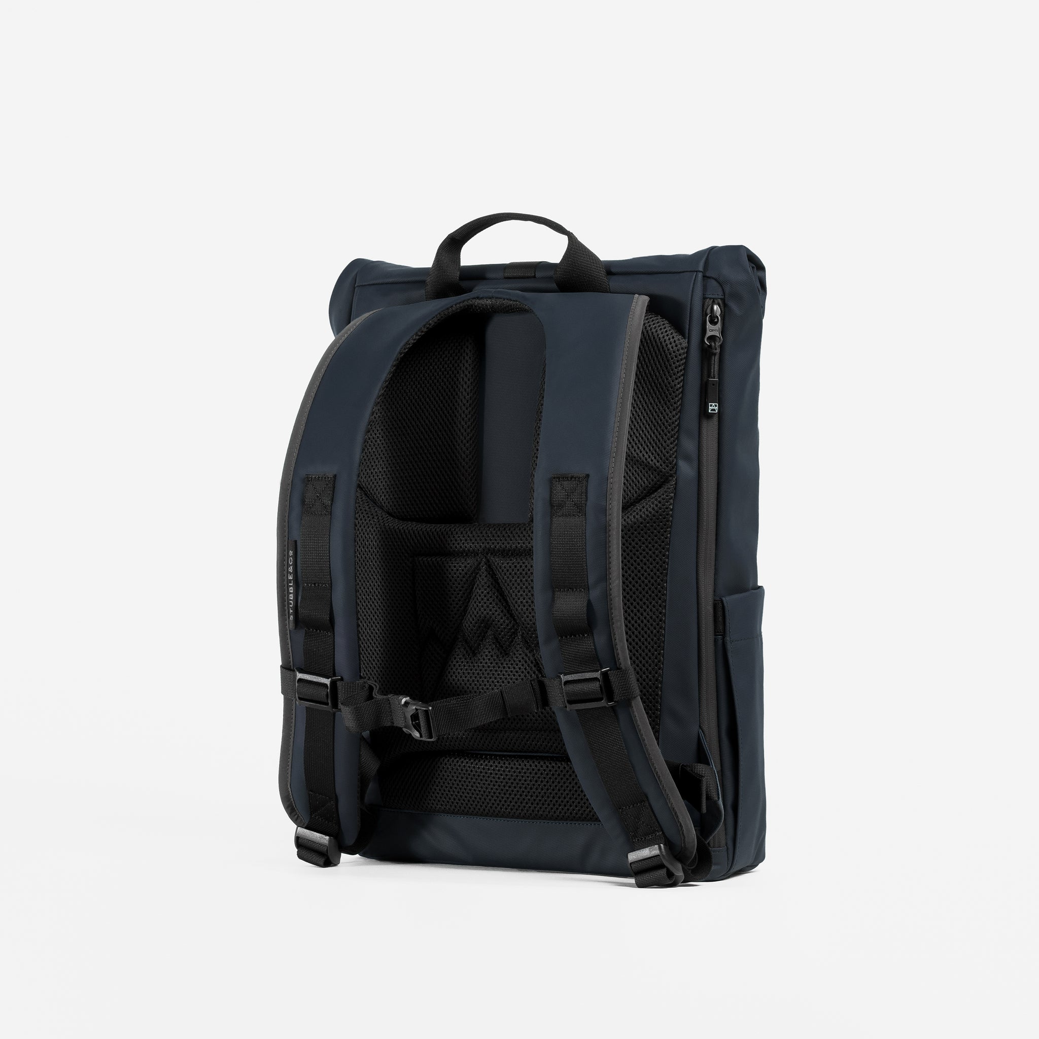 A studio shot of the back panel and adjustable chest straps on the Midnight Blue Roll Top 15L